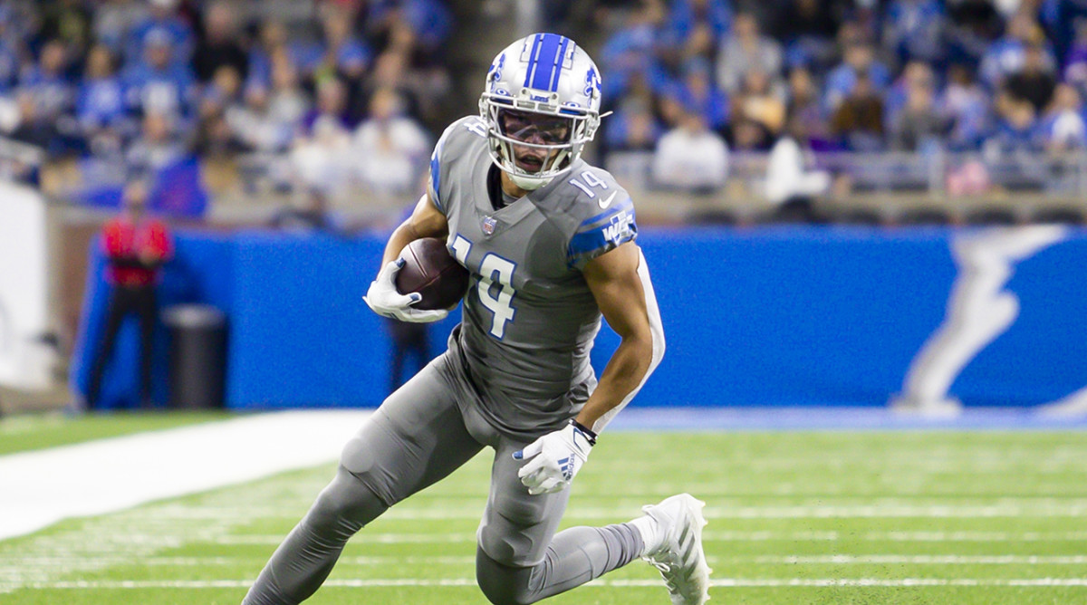 Lions wide receiver Amon-Ra St. Brown (14) runs with the ball.